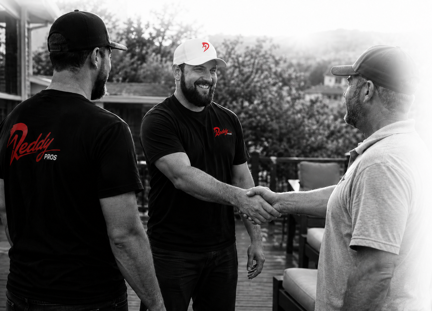 Reddy Pros team members shaking hands with a client