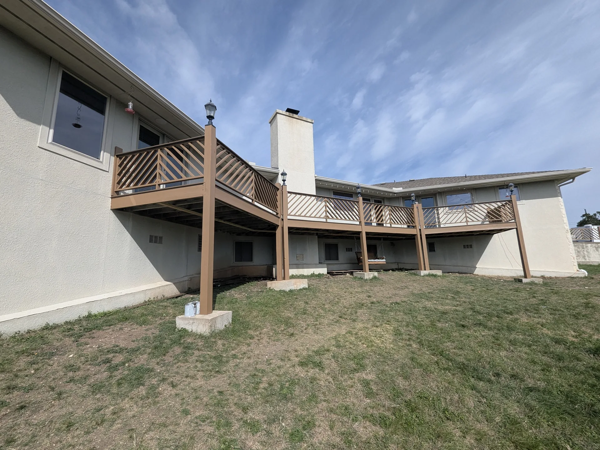 Finished elevated deck resurfaced with Trex decking and rebuilt painted handrails