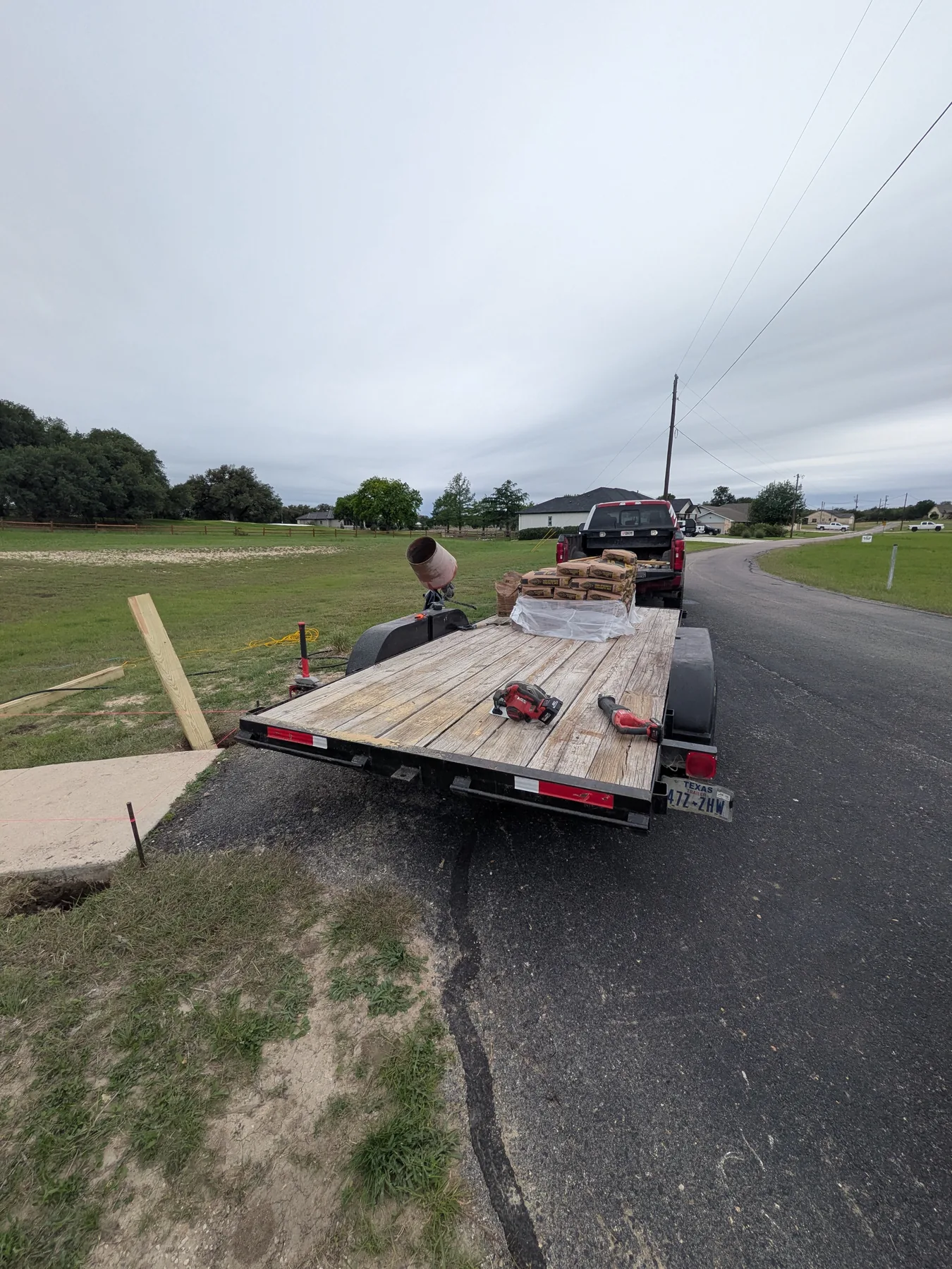 Concrete bags on trailer for boardwalk post installation