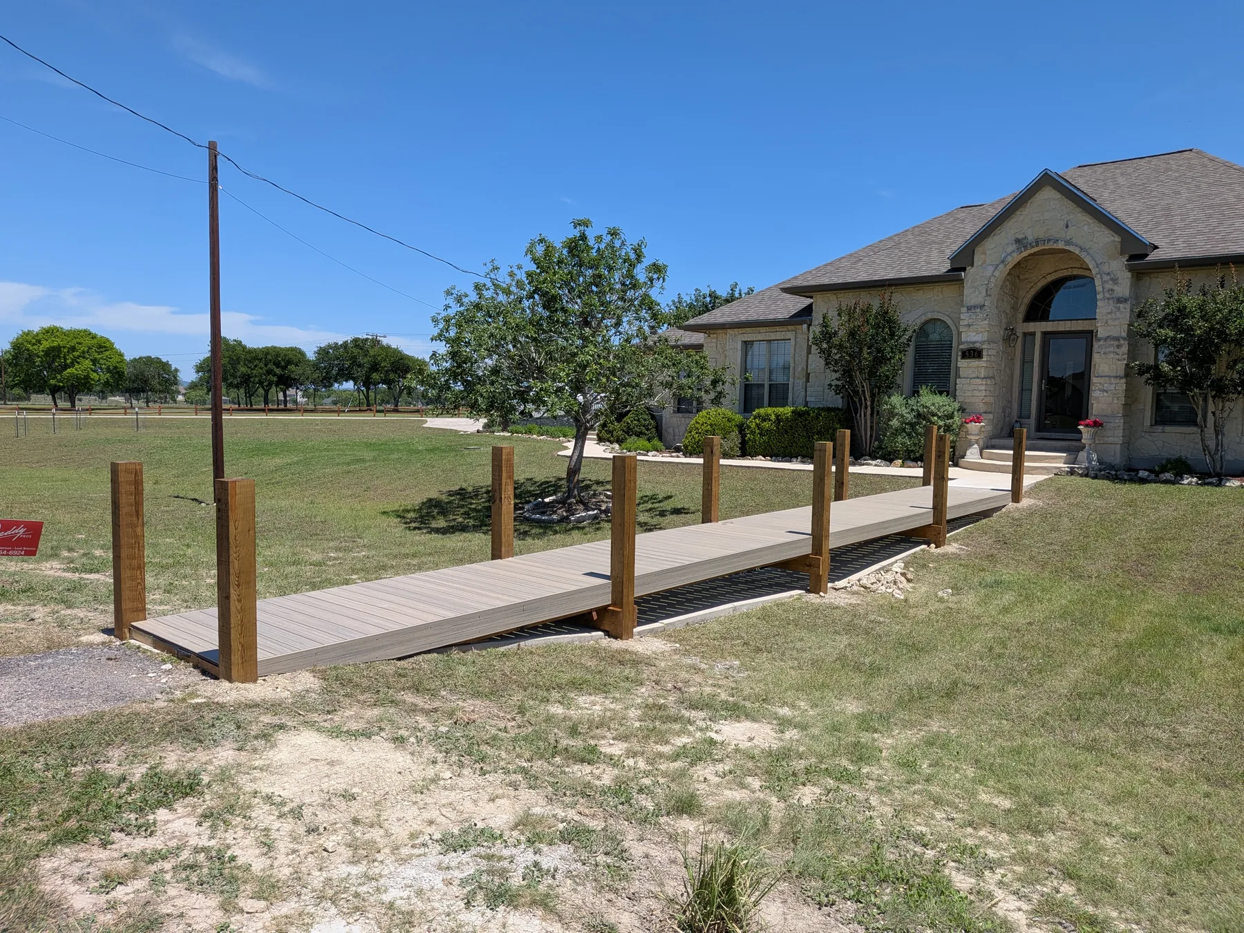 Completed Trex boardwalk bridge with extended posts and rope railing