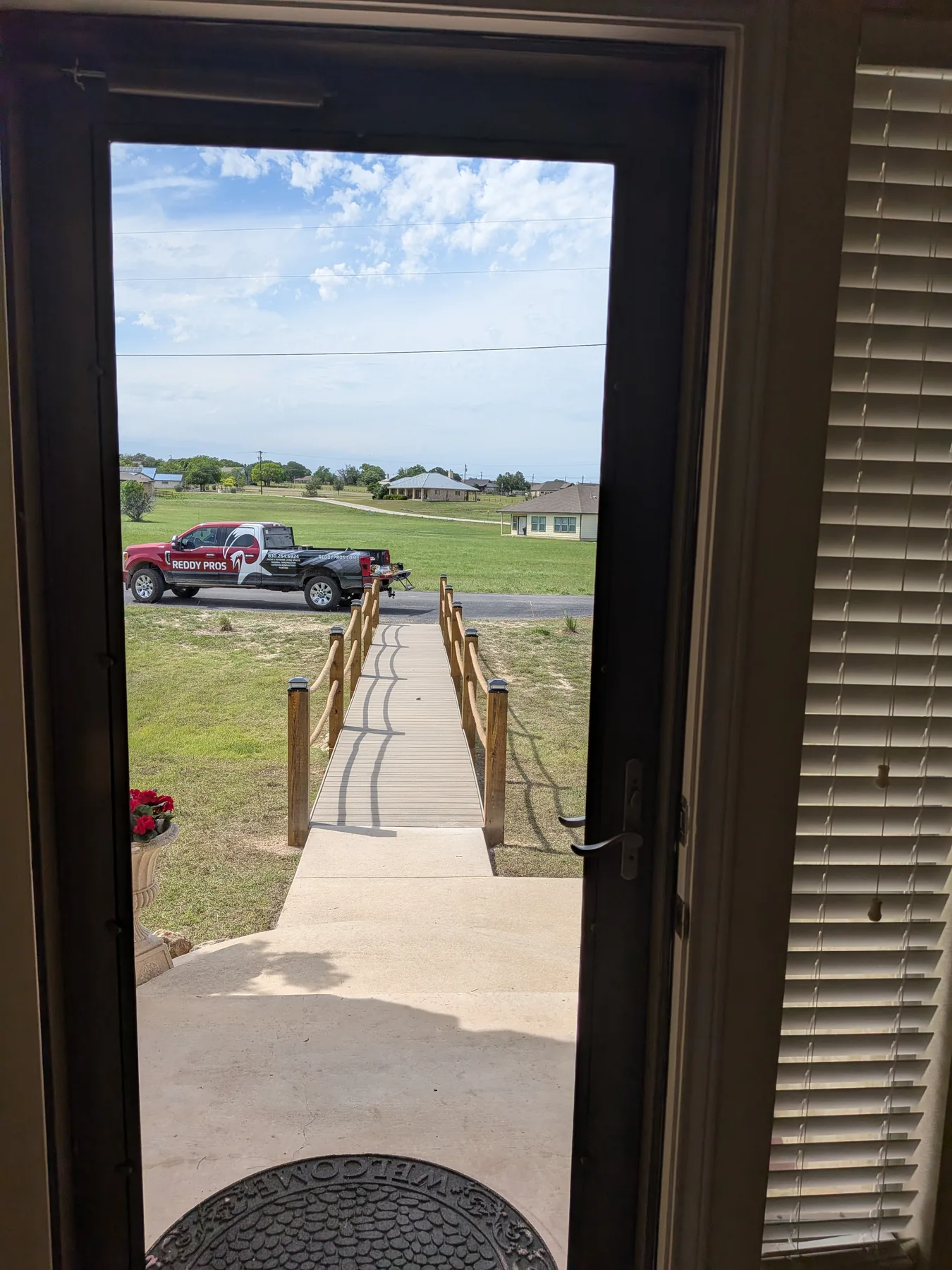 View from the front door looking down the new boardwalk bridge toward the parking area