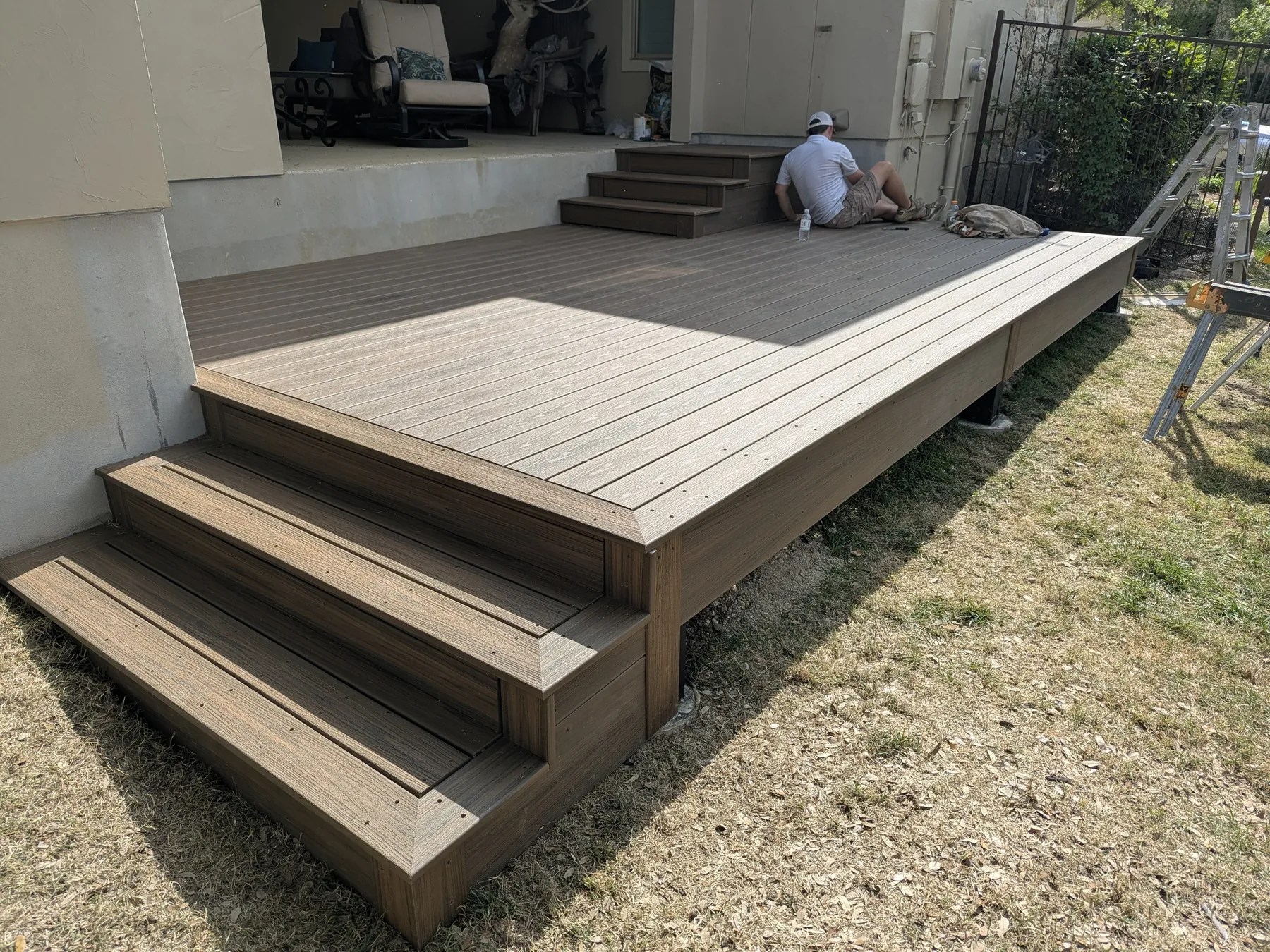 Wide low-rise easy-tread Trex steps leading from the deck into the yard
