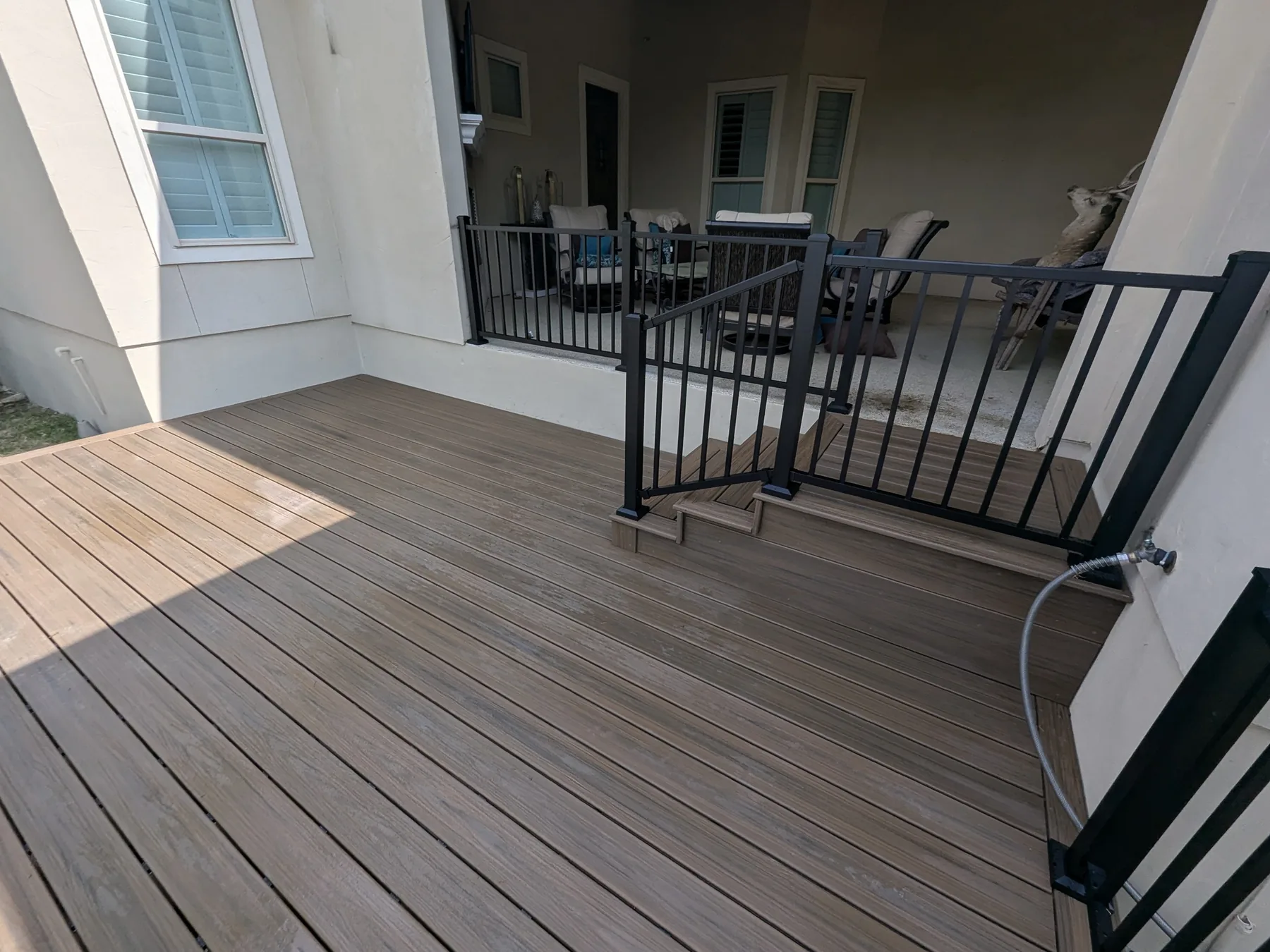 Finished Trex deck viewed from the patio with metal railing