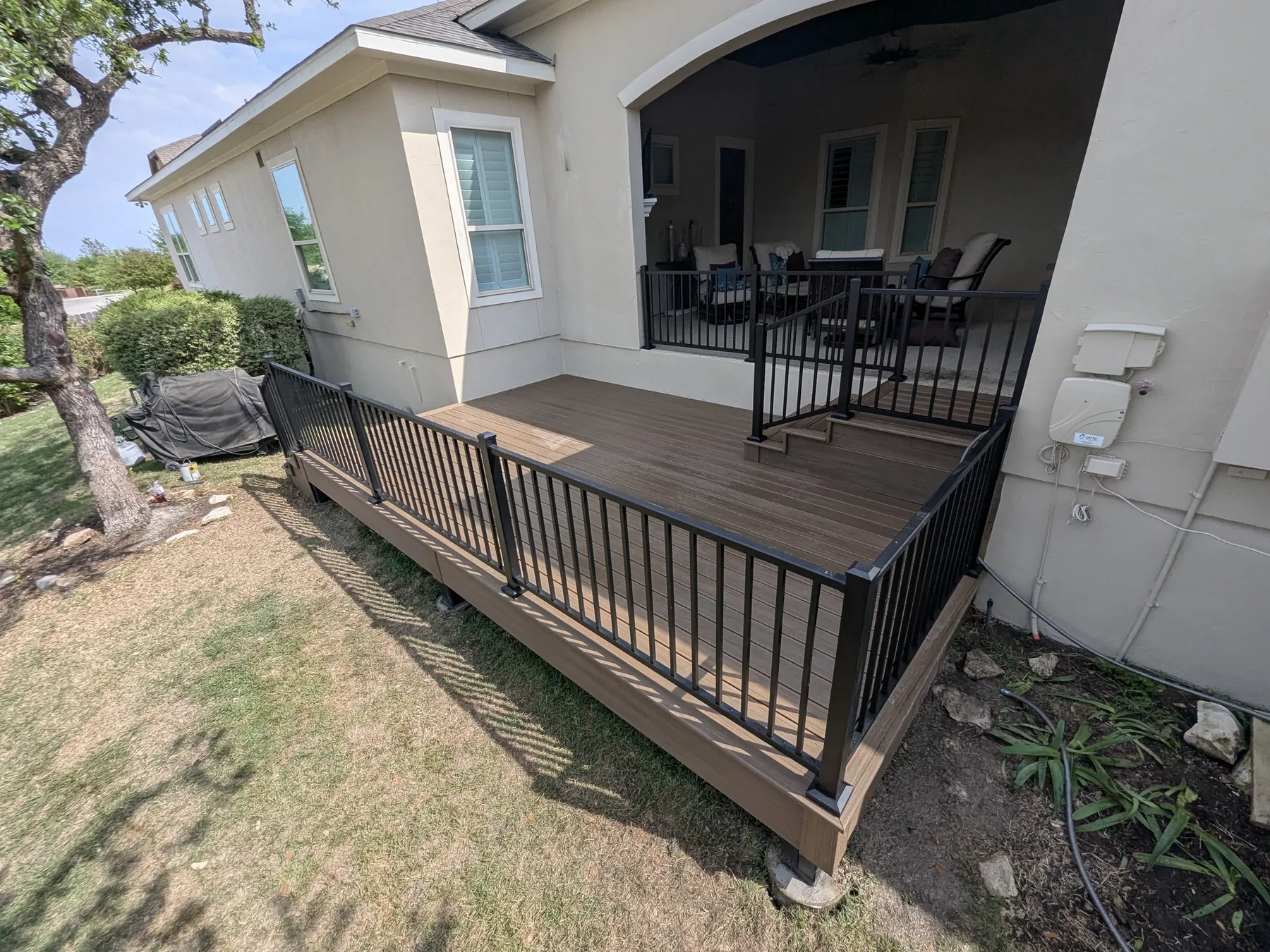 Finished Scenic Oaks Trex deck with railings and refreshed exterior details