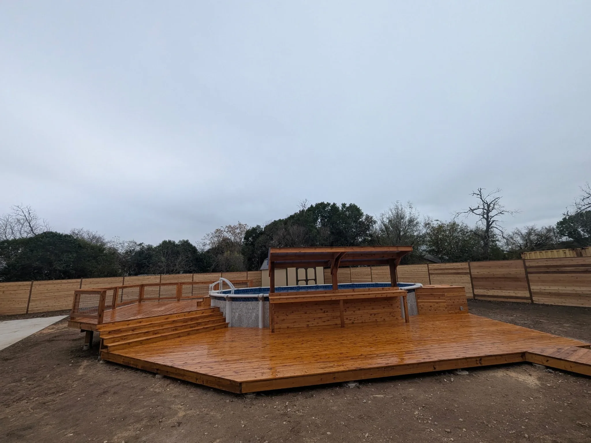 Finished lower level of cedar pool deck with open gathering area
