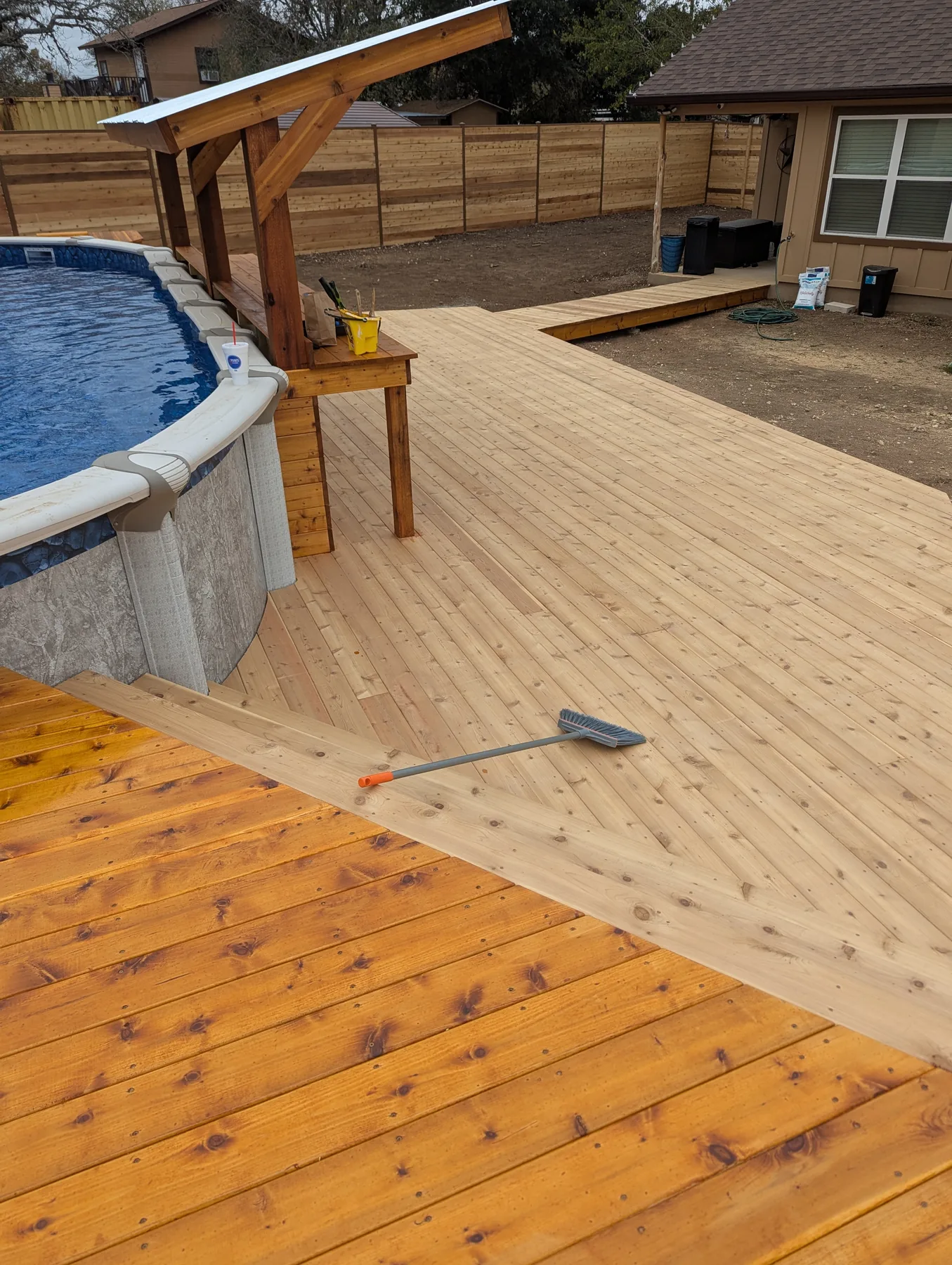 Cedar pool deck showing the difference between stained and unstained boards