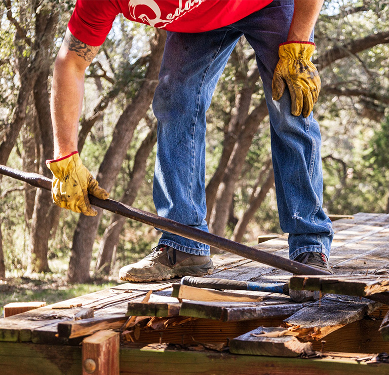 Remodeling and Deck Builder working on demoing a deck before rebuilding a new deck.