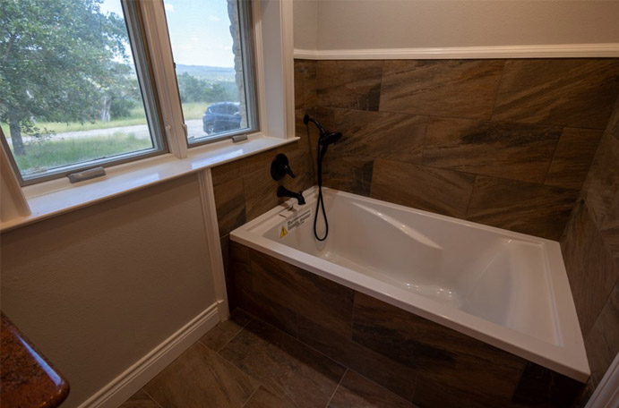 Dark tile tub surround in the Hill Country.
