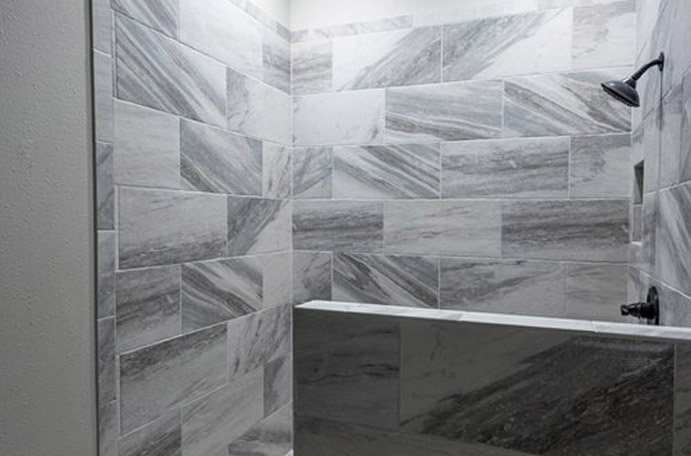 Modern grey tile shower in high-end bathroom remodel.