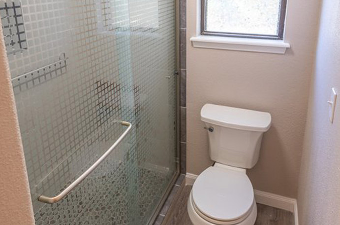 A Kerrville glass shower door on a new tiled shower.